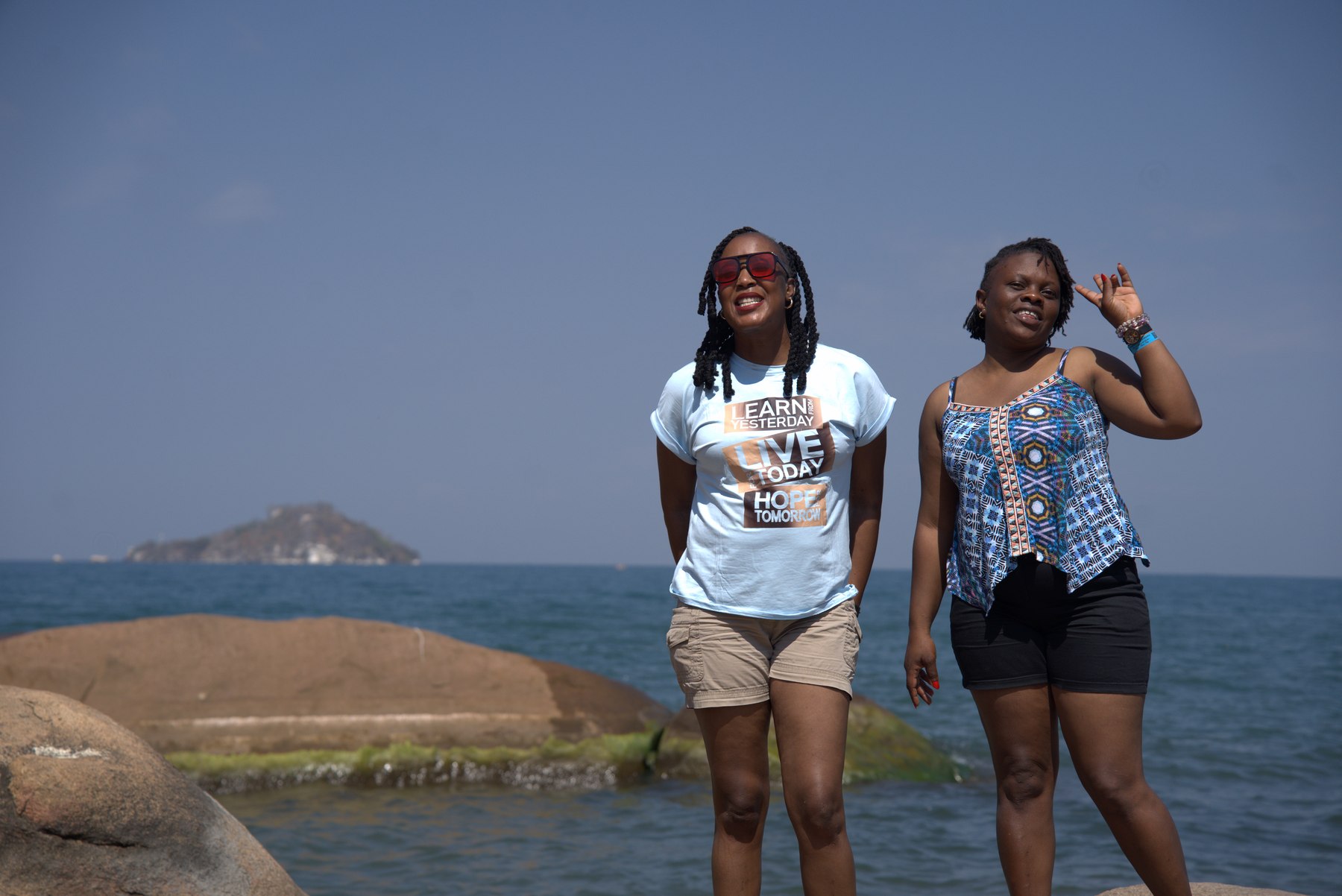 Travellers at the water's edge on the Lake Malawi border hop